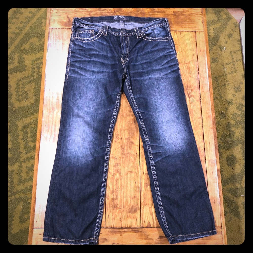 Dark wash jeans with brown stitching